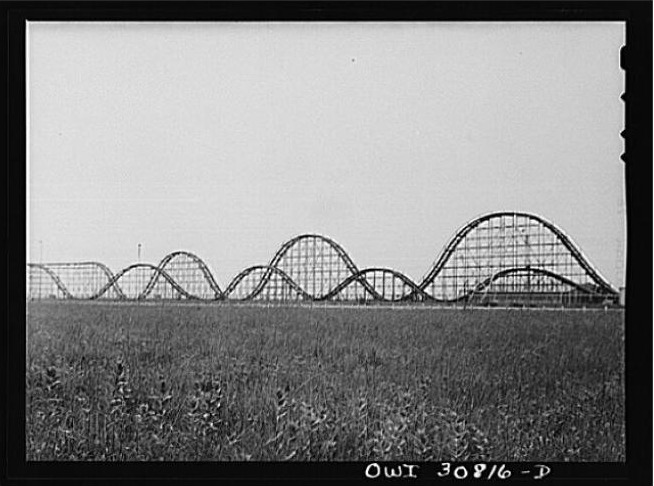 A black and white 1943 photograph of the Skyrocket roller coaster at Playland Park in Houston, Texas, with its wooden structure and track rising against the sky.